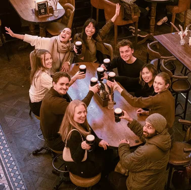 London pub tour guide leading guests past historic pubs